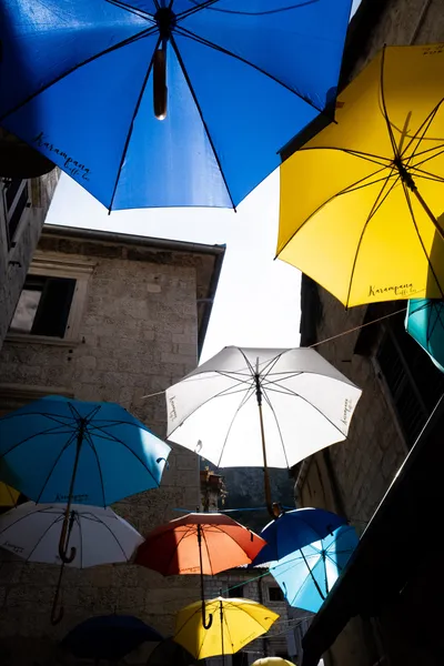 Colorful umbrellas in an alleyway