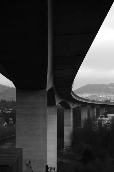 Curved concrete bridge in black and white