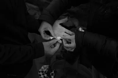 Hands connecting fingers after bouldering in black and white