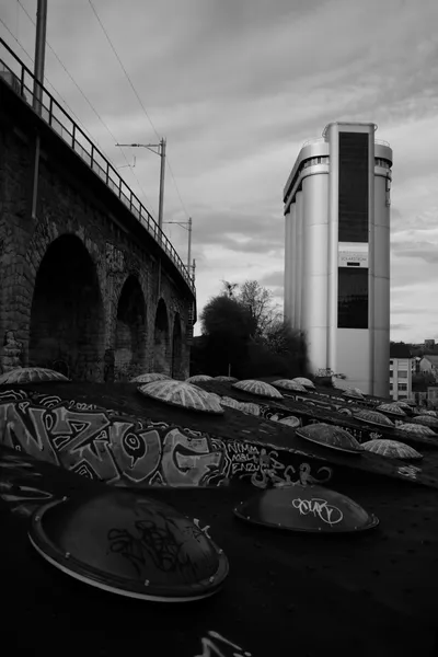Skate park with graffiti under the railway bridge in black and white