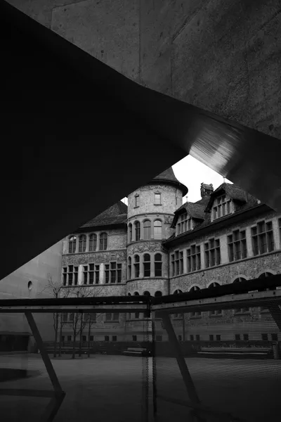 Historic building framed by modern architecture in black and white